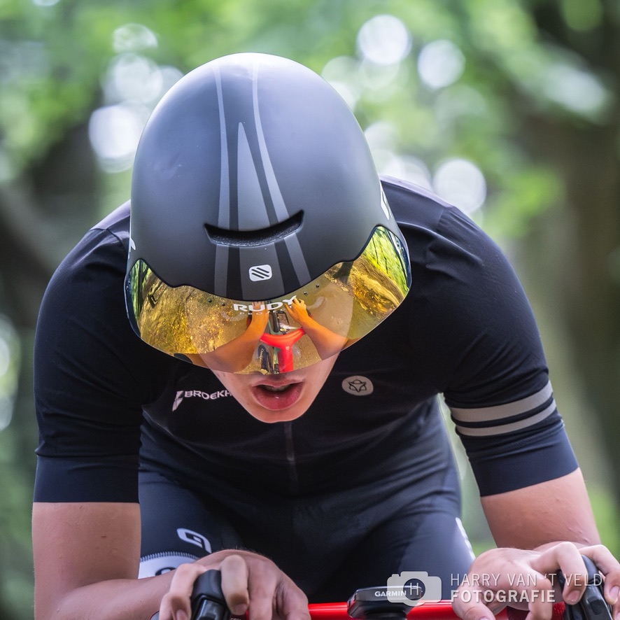 Time-trial cyclist wearing a gold visor